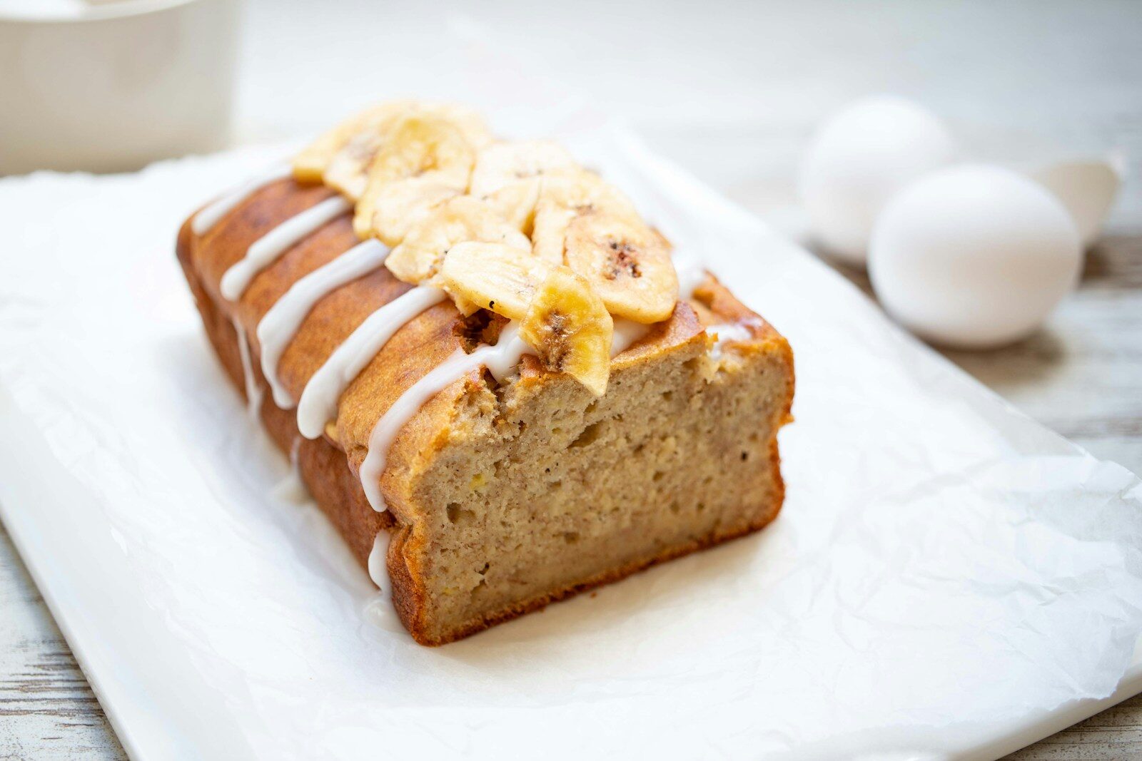 a loaf of banana bread sitting on top of a white plate