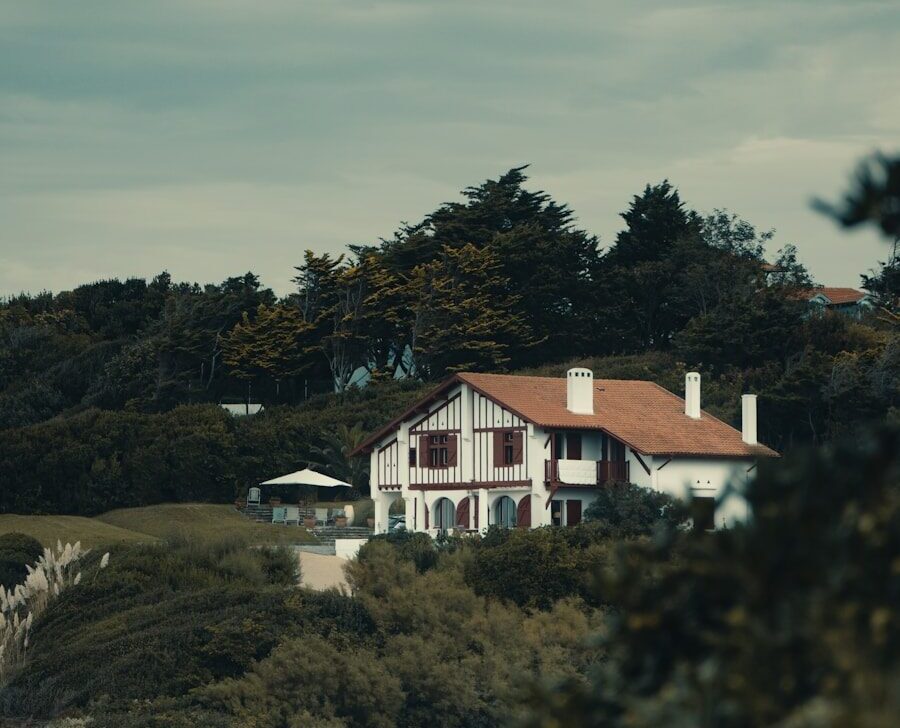 a house on a hill with trees in the background